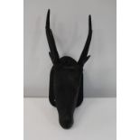 An unusual hand carved & mounted wooden deers head 57cm tall