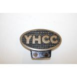 A vintage YHCC car bumper badge 11cm wide