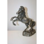 A heavy bronze and silver tone study of a rearing horse 32cm x 34cm