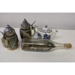 A vintage Ringtons teapot, two German beer steins and a ship in a bottle
