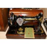 A vintage cased Singer sewing machine in very good condition etc Collection Only