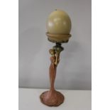 A vintage resin figure with a ostrich egg on top h48cm