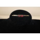 A 9ct gold three pink stone bar brooch