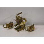 Three solid brass elephants. largest 30cm tall