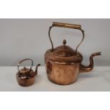 A large copper kettle and smaller one