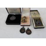 Four hallmarked silver pendants and one other awarded to G.T Sismey