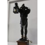 A large vintage hollow cast bronze figure in the form of a table lamp with signature to base 70cm