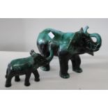 Two green ceramic elephants largest 29cm tall x 40cm long