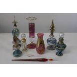 A selection of vintage coloured glass perfume bottles etc