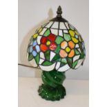 A Tiffany style lamp on a green glass base 33cm tall