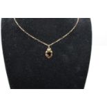 A 9ct gold 24 inch belcher chain with a 9ct gold smokey quartz pendant