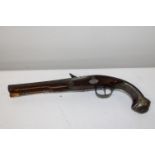 A antique flintlock pistol with white metal mounts and very ornately engraved. 22 bore