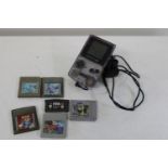 A vintage Gameboy and selection of games untested