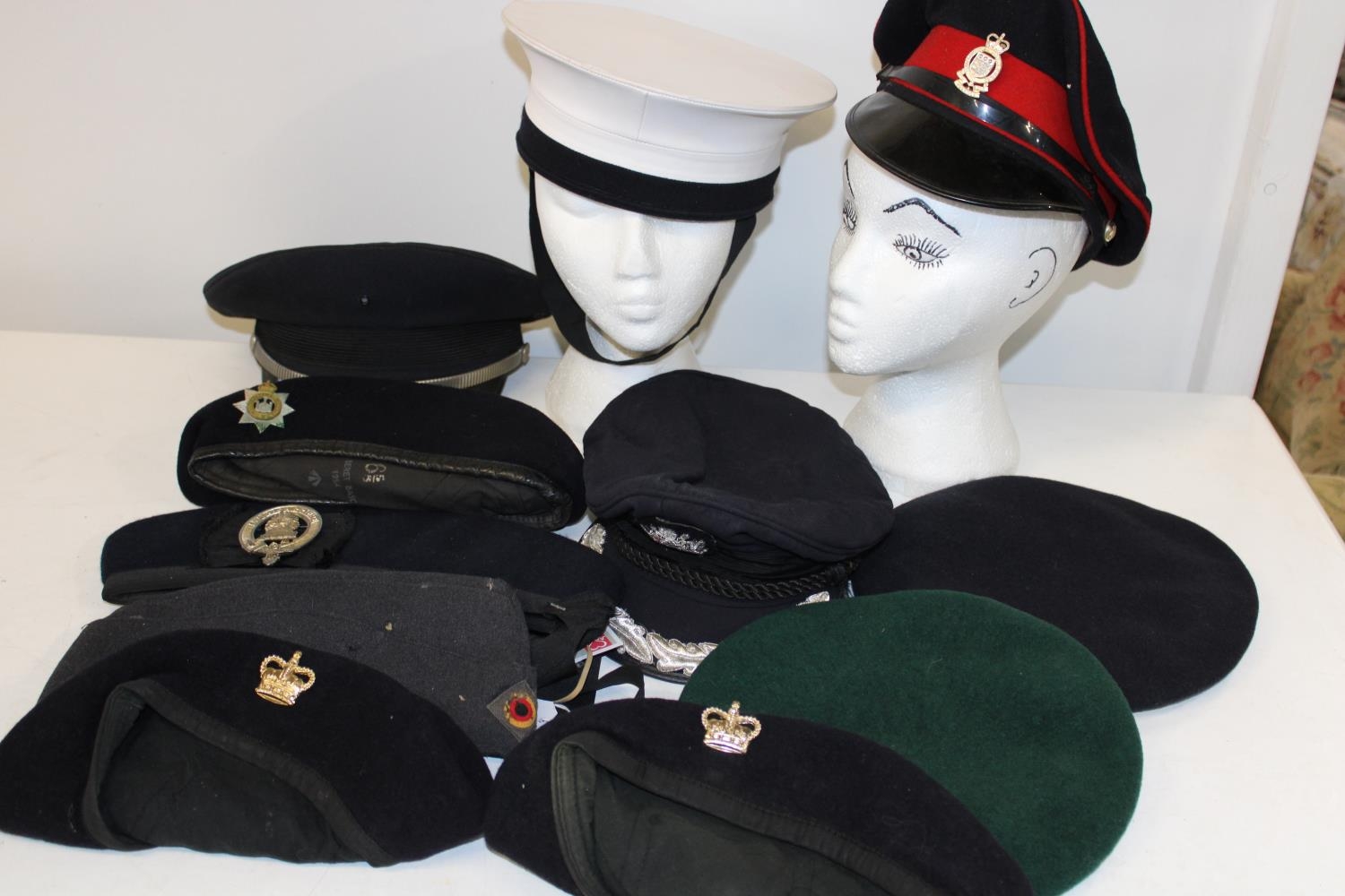 A box of assorted military hats/caps etc