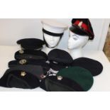 A box of assorted military hats/caps etc
