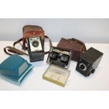 A box of assorted vintage cameras etc