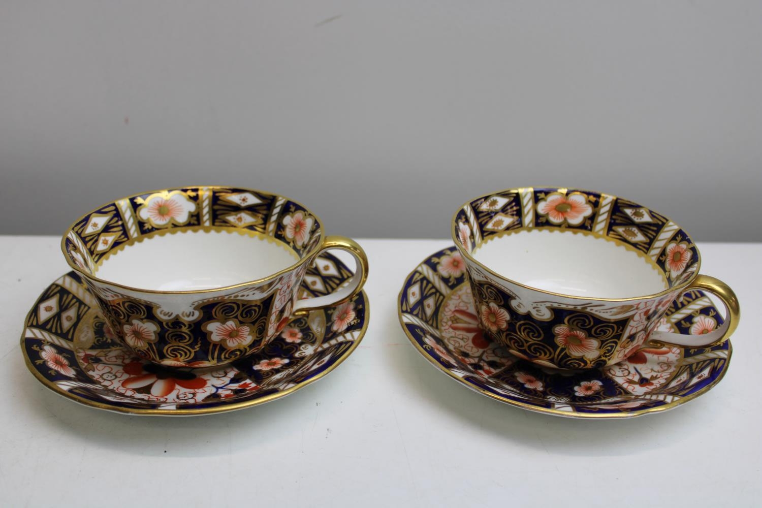 A pair of Royal Crown Derby cups & saucers (2451)