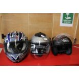 Three crash helmets