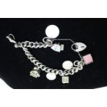 A silver charm bracelet & charms 70 grams total