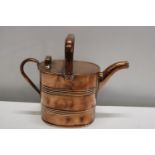 A vintage copper watering can