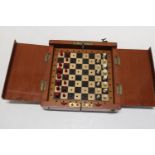 An Edwardian period travelling chess set (one piece missing)