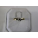 A 18ct gold trilogy ring size Q 1/2 with a diamond centre stone