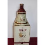 A sealed bottle of Bells Christmas whisky 1997