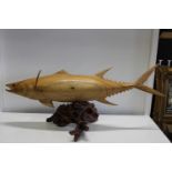 A large hand carved wooden tuna model on a driftwood base Length 106cm x height 40cm. Collection