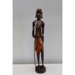 A large hand carved wooden African figure 61cm height