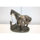 A vintage blacksmith & horse sculpture