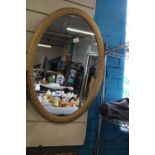 A large gold framed oval mirror, Postage unavailable