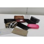 A job lot of designer sun glasses cases