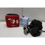 A selection medical equipment including blood pressure monitors and a defibrillator.