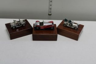 Three Lesney car models in the form of boxes