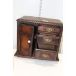 A vintage wooden jewellery cabinet