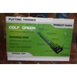 A boxed golf putting trainer