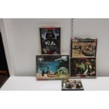 Four vintage Star Wars puzzles & box of Star Wars chocolates (un-checked)