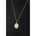 A 9ct gold chain & 9ct gold Front & back pendant