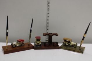 Three novelty desk top car models