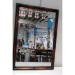 A wooden framed & bevelled edge mirror