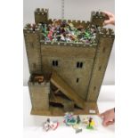 A wooden castle & draw bridge model with a large qty of mainly Britain's models, postage unavailable