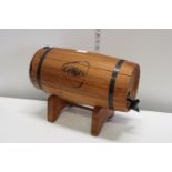 A Grant's whiskey barrel on wooden stand