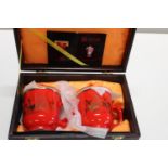 A pair of boxed China red ceramic teacups with lids