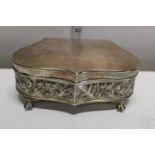 An Edwardian silver repousse heart shaped jewellery casket with hinged lid. Decorated with scrolling