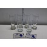 Six advertising beer glasses