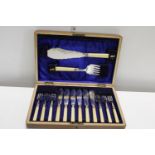 A vintage oak cased cutlery set