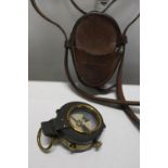 A WW1 military compass with leather case and shoulder strap. dated 1916. Compass by E R Watts & Sons