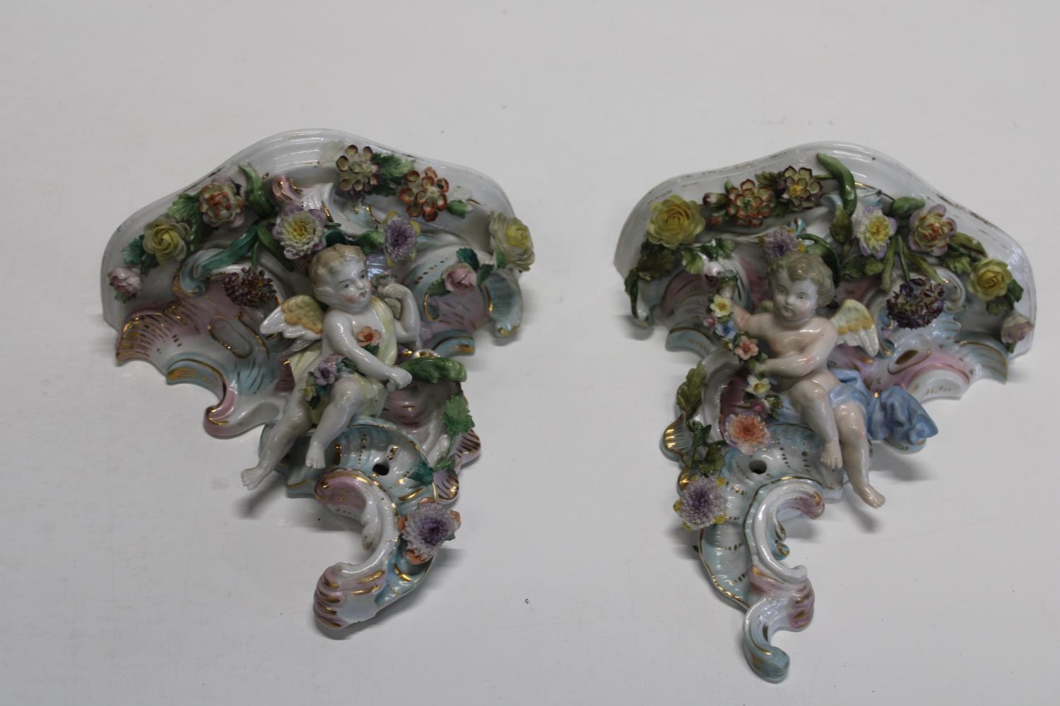 A pair of German Sitzendorf porcelain wall sconces