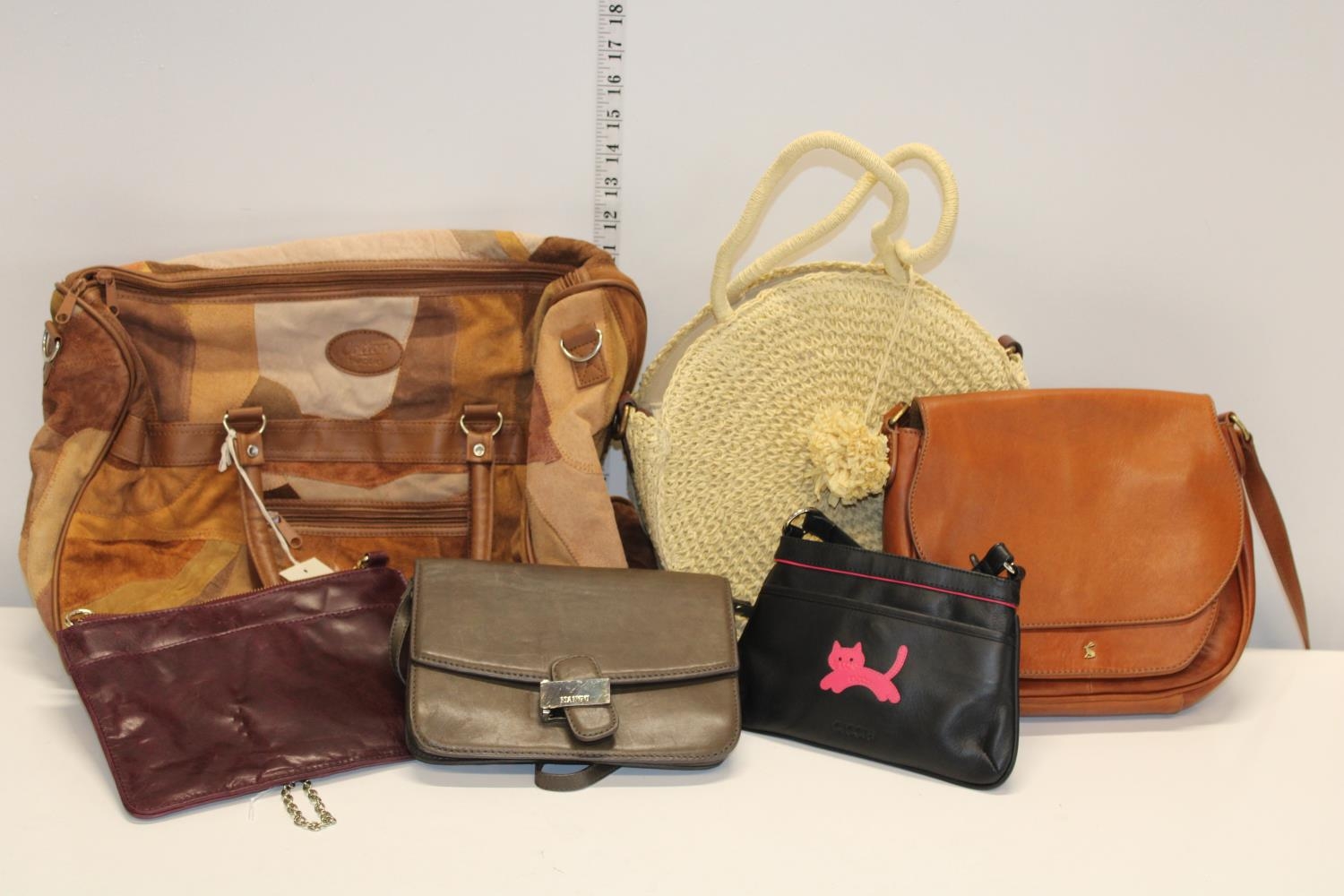 A qty of assorted hand bags high strret brands including Joules and Cotton Traders