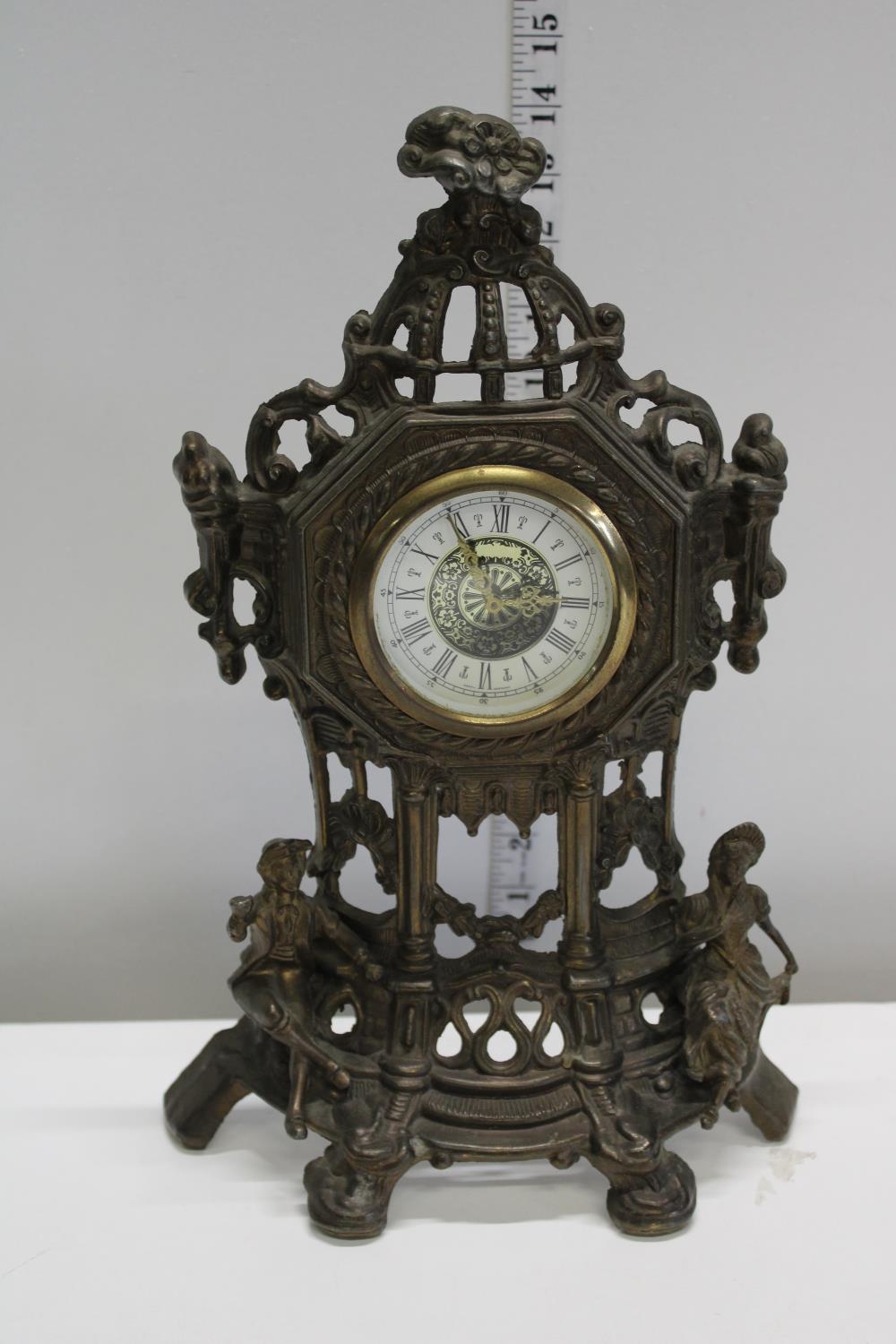 A cast metal mantel clock